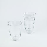 Set of clear glass tumblers on a light gray background