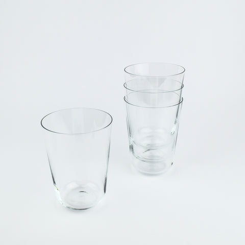Set of clear glass tumblers on a light gray background