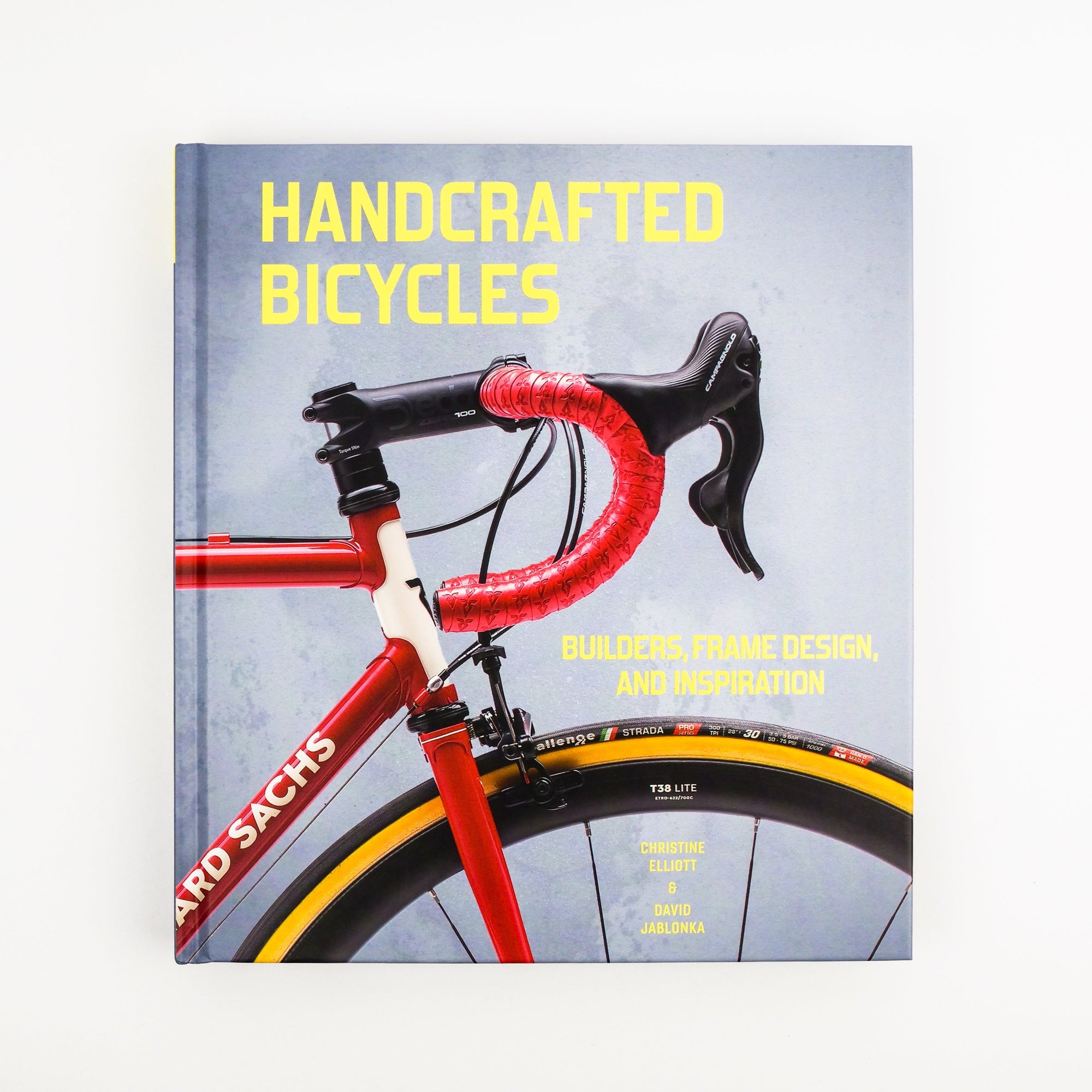 Book cover of 'Handcrafted Bicycles' with a red bicycle on a gray background