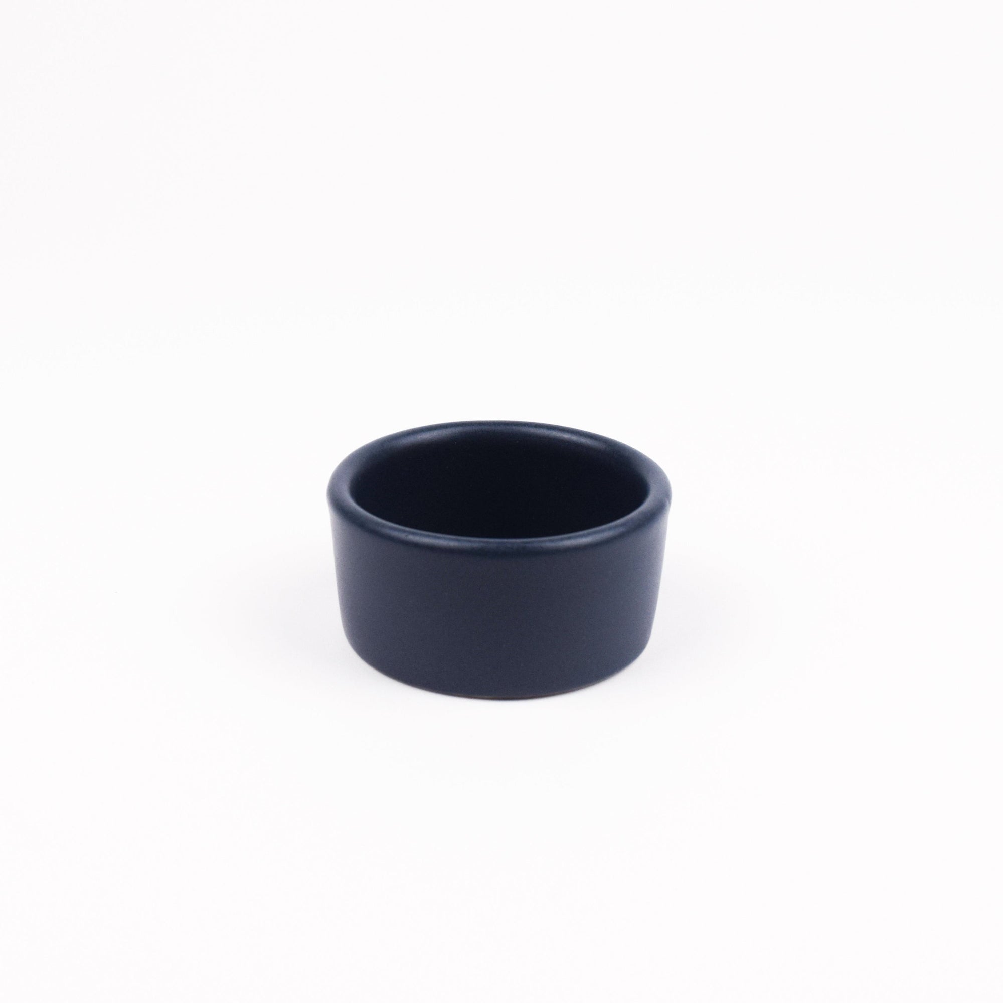 Navy blue ramekin on a white background