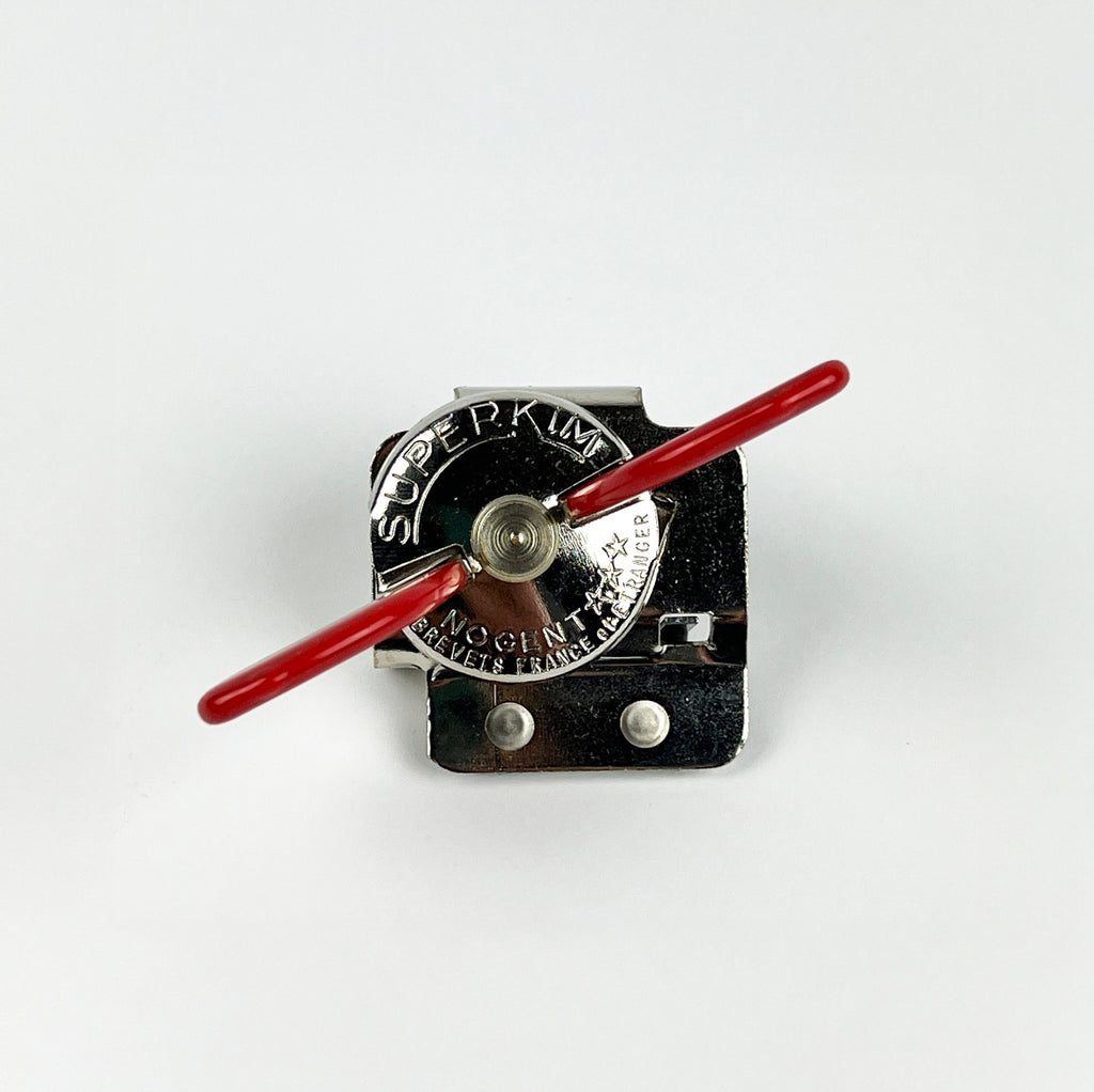 Can opener with red lever and 'Super Kim' branding on a white background
