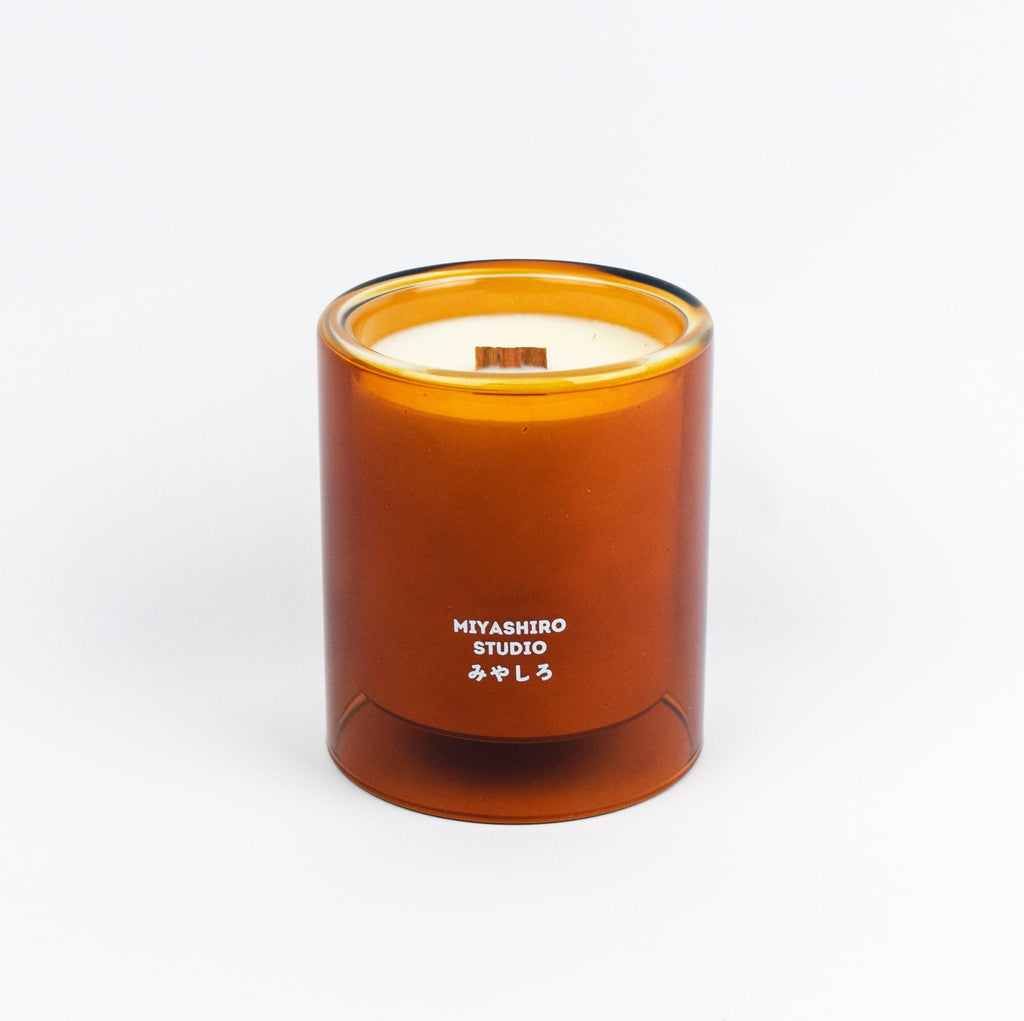 Miyashiro Studio candle in an amber glass jar on a white background