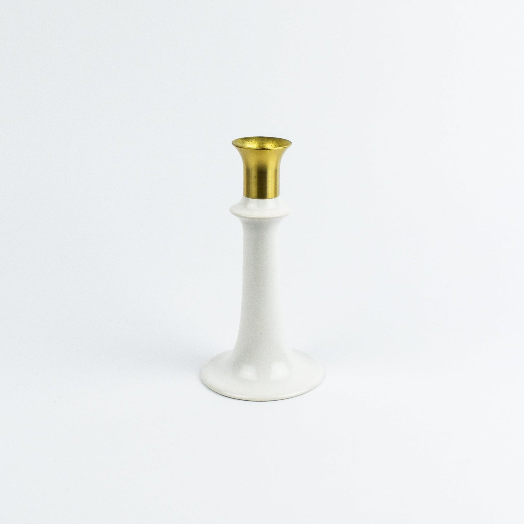 White candle holder with gold top on a white background