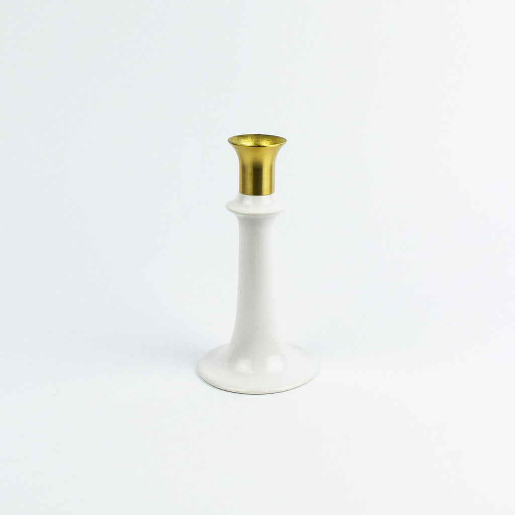 White candle holder with gold top on a white background