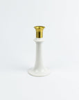 White candle holder with gold top on a white background
