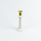 White candle holder with gold top on a white background
