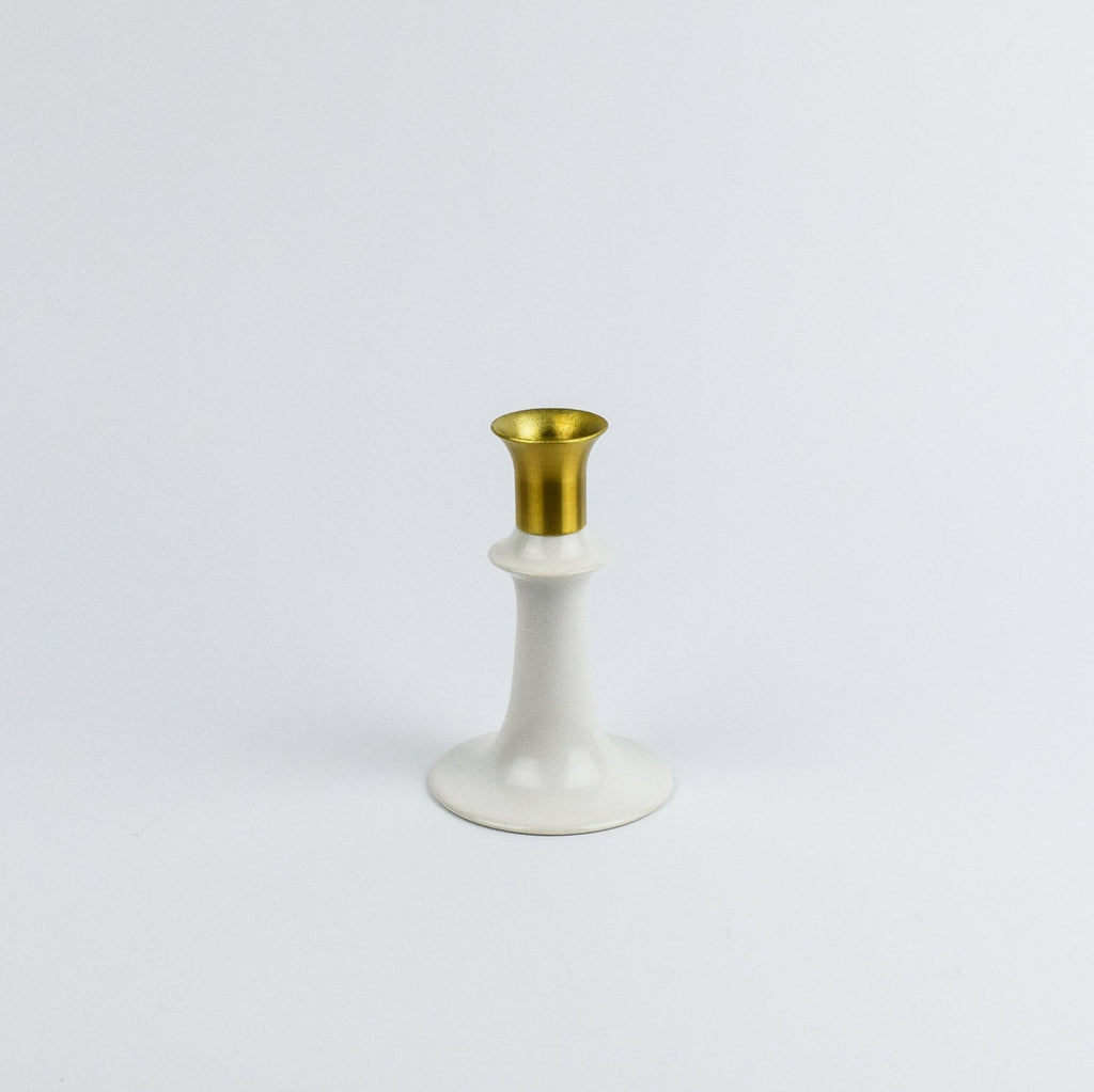 White candle holder with gold top on a white background