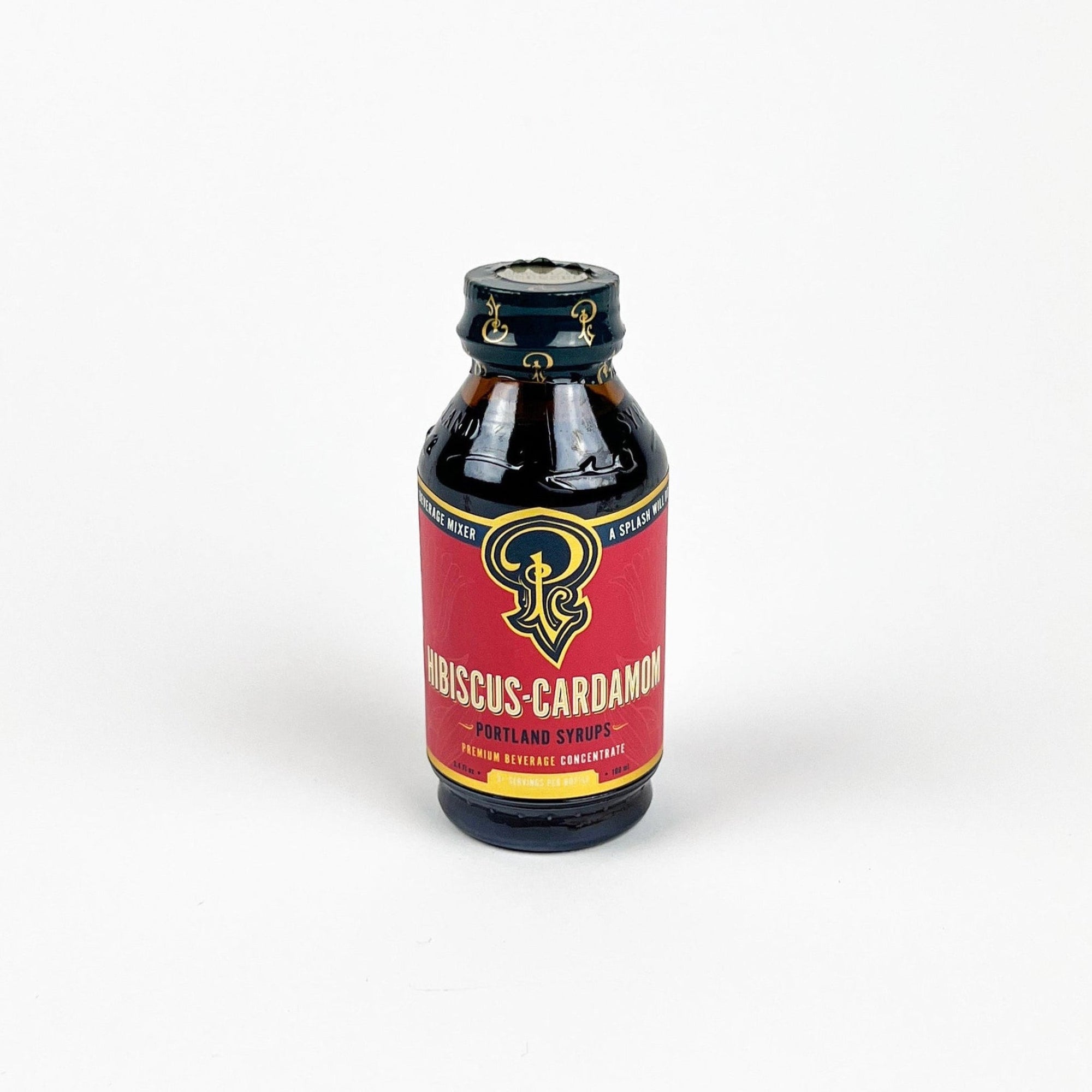 Bottle of Hibiscus Cardamom syrup with a red label on a white background
