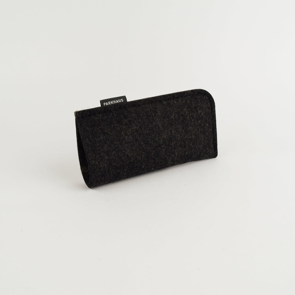 Black eyeglass case with 'PARKHAUS' label on a light gray background