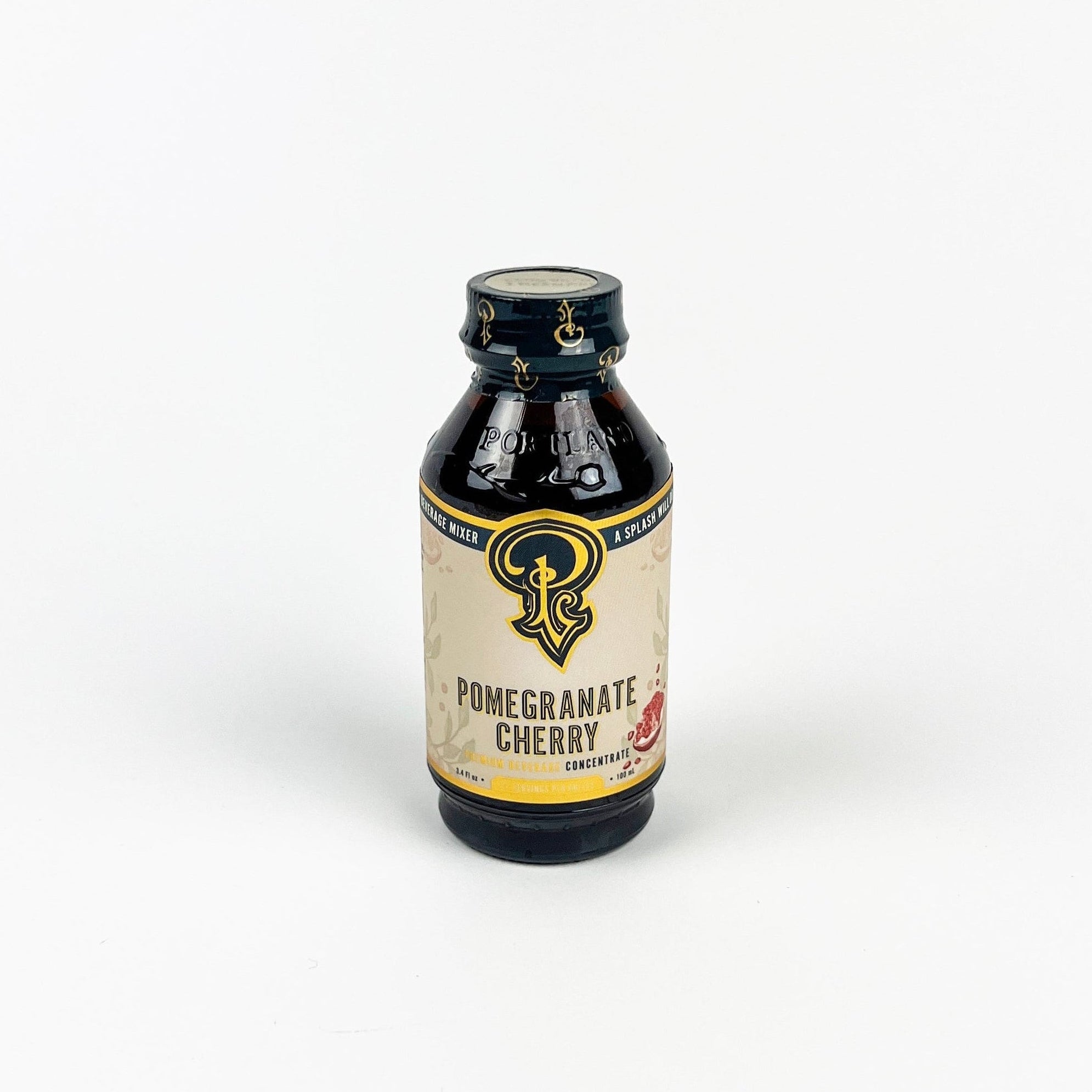 Bottle of Pomegranate Cherry concentrate with a visible label on a white background
