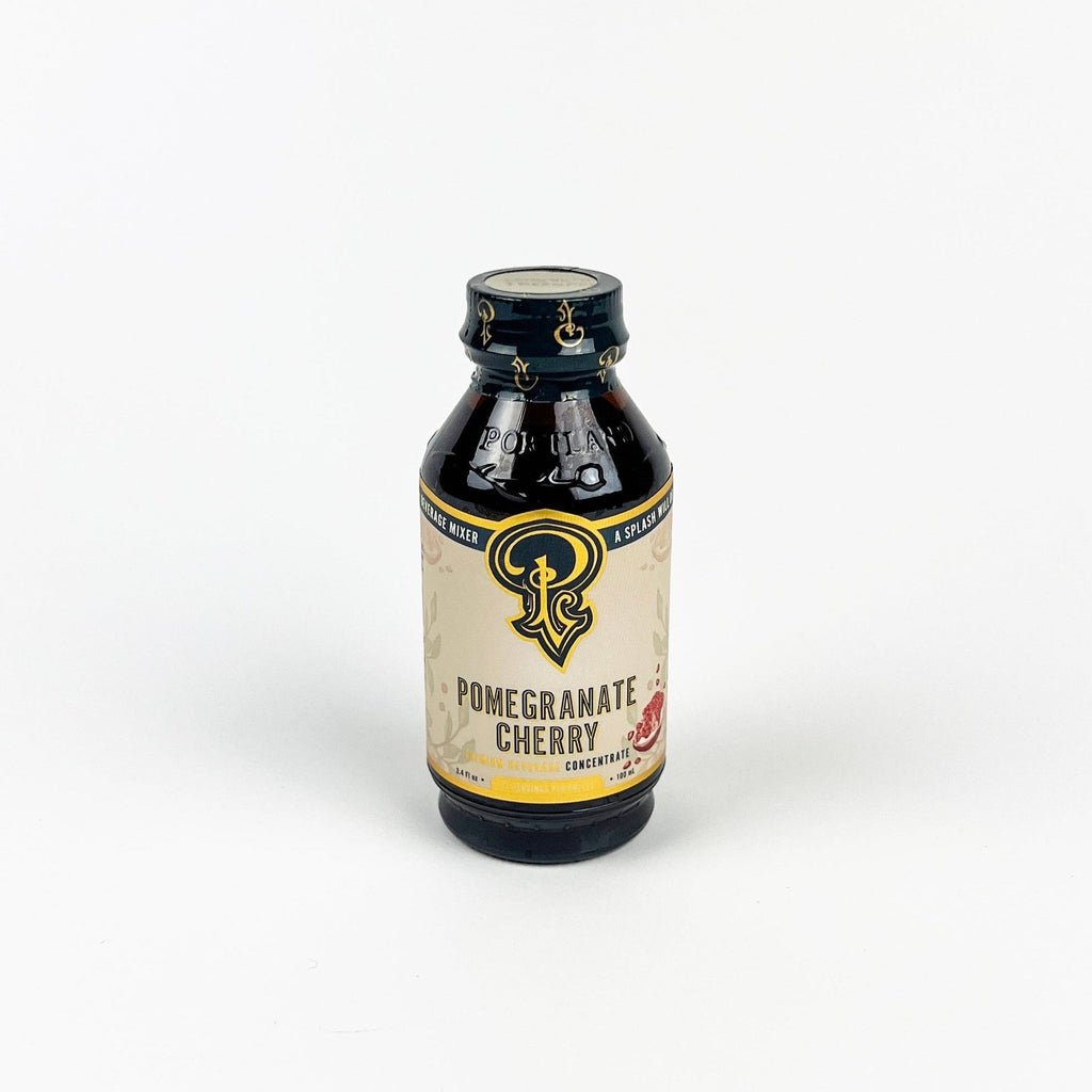 Bottle of Pomegranate Cherry concentrate with a visible label on a white background