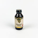 Bottle of Pomegranate Cherry concentrate with a visible label on a white background