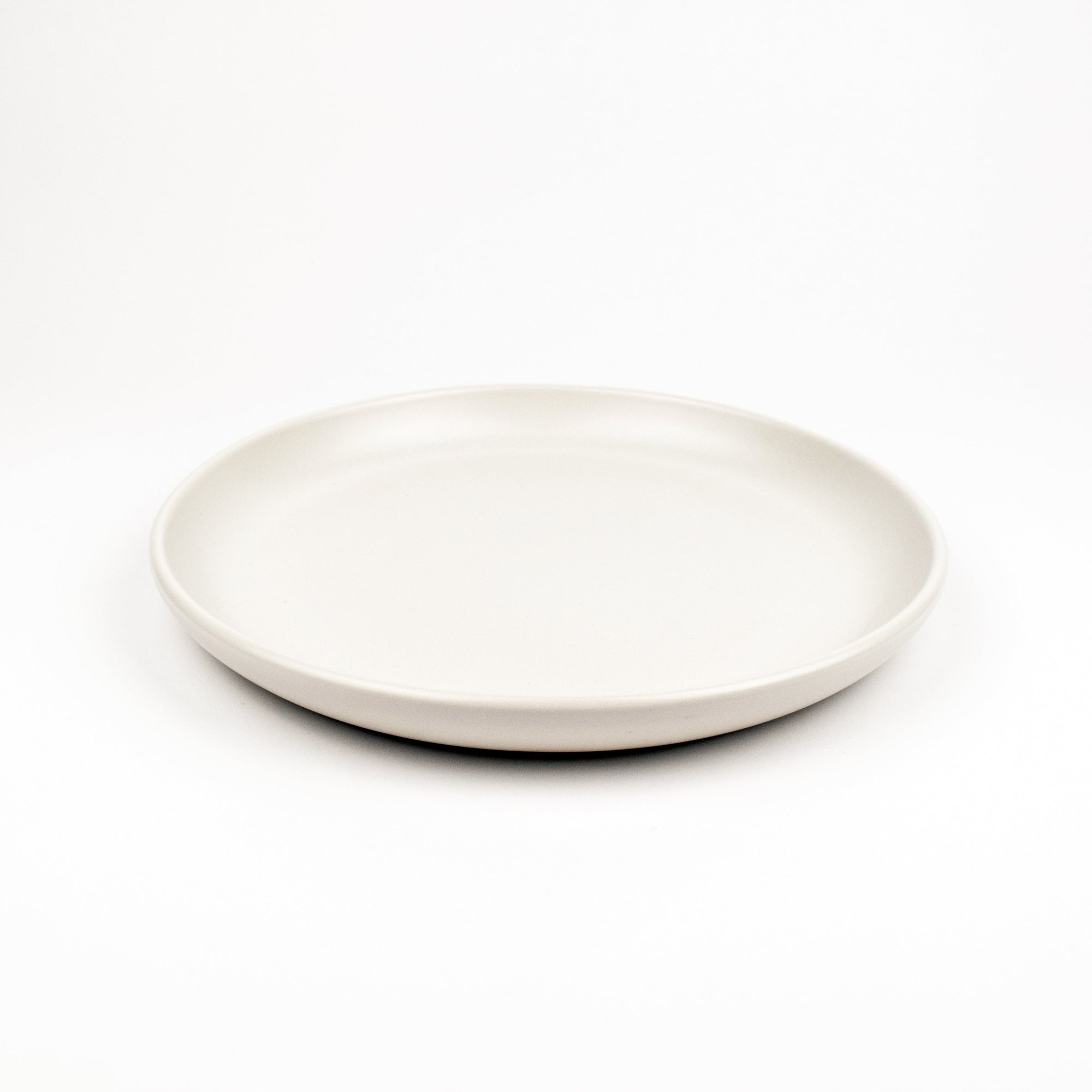 White ceramic plate on a white background