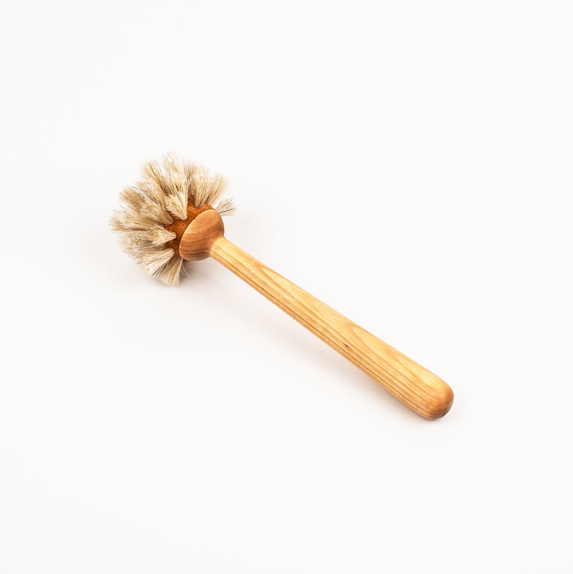 Wooden handled dish brush with natural bristles on a white background