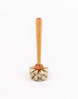 Wooden handled dish brush with natural bristles on a white background