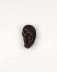 Bronze ear sculpture on a white background