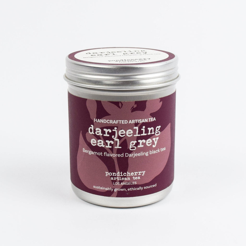 Darjeeling Earl Grey tea canister with purple label on a white background
