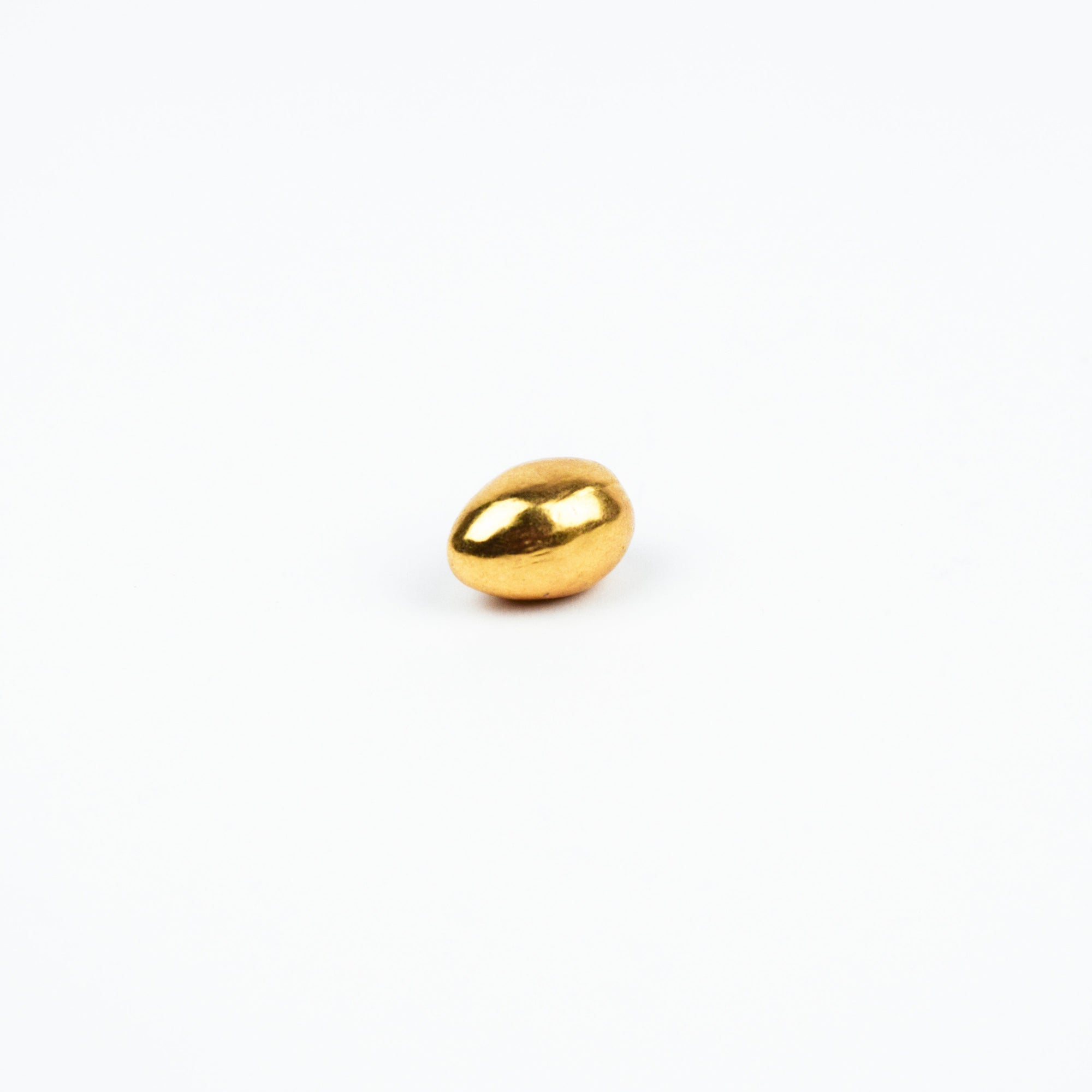 Gold egg-shaped object on a white background
