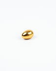 Gold egg-shaped object on a white background
