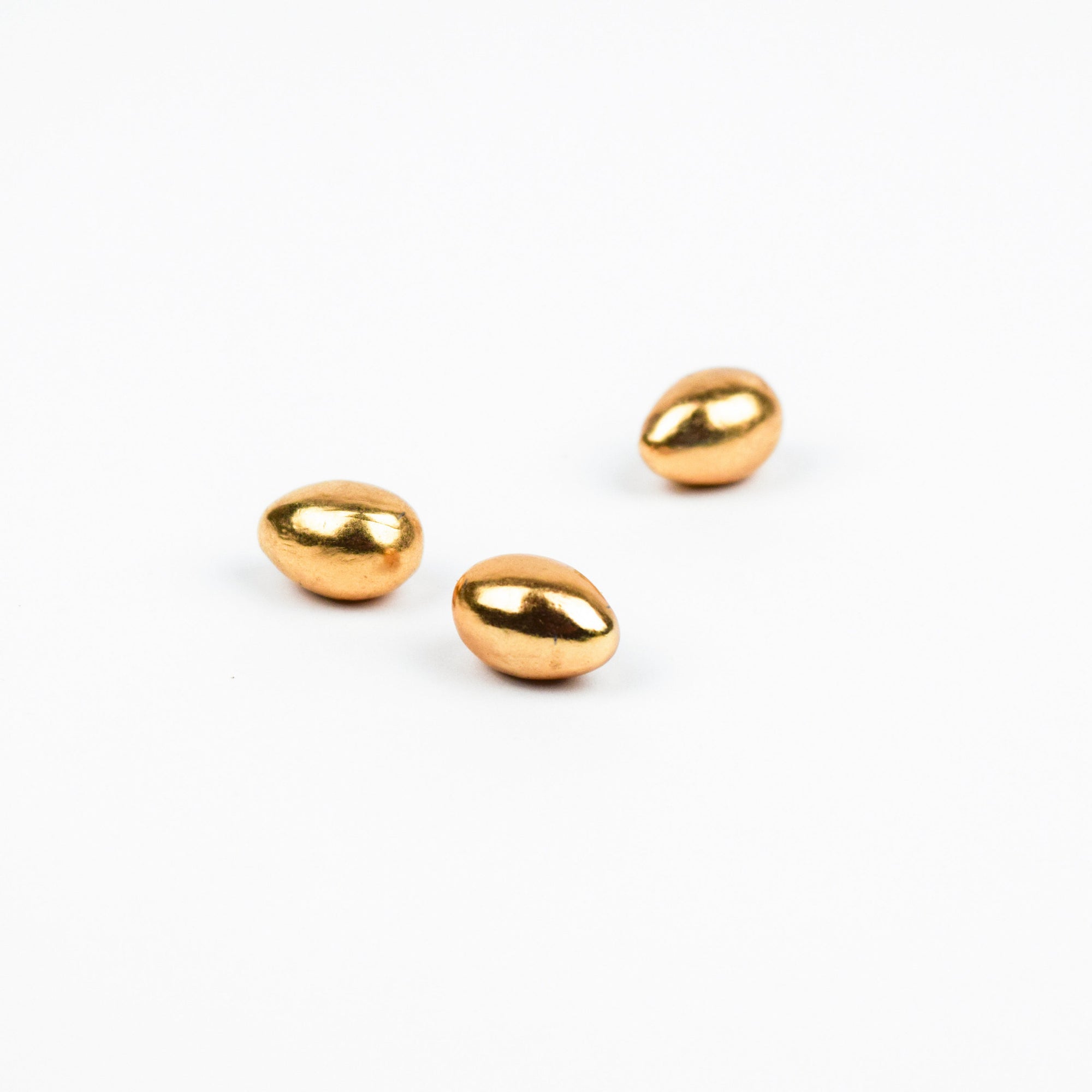 Three gold egg forms on a white background