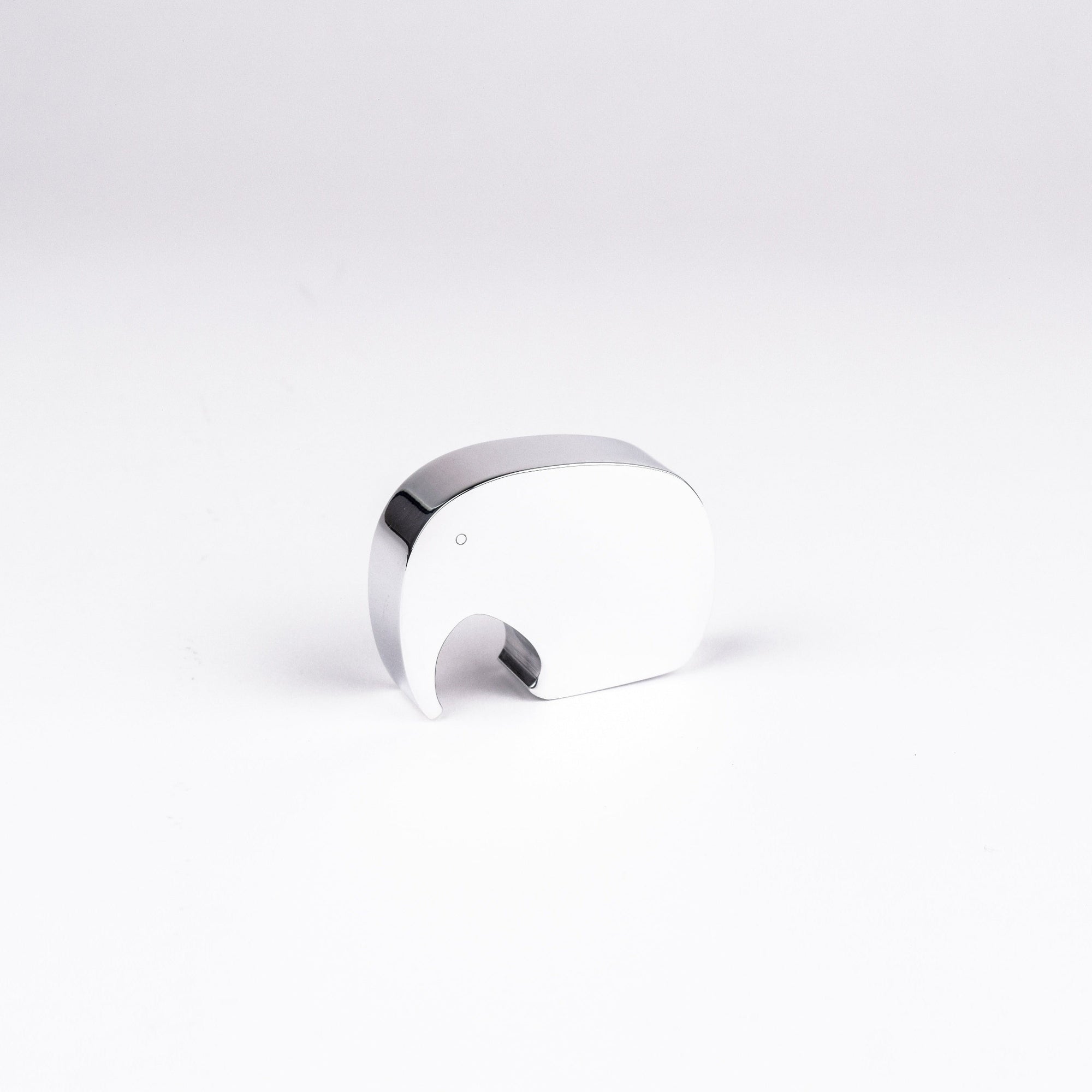 A small polished chrome elephant figurine on a seamless white background.