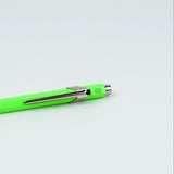 Neon green pen with silver clip on a light gray background