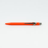 Orange pen with a metallic clip on a white background