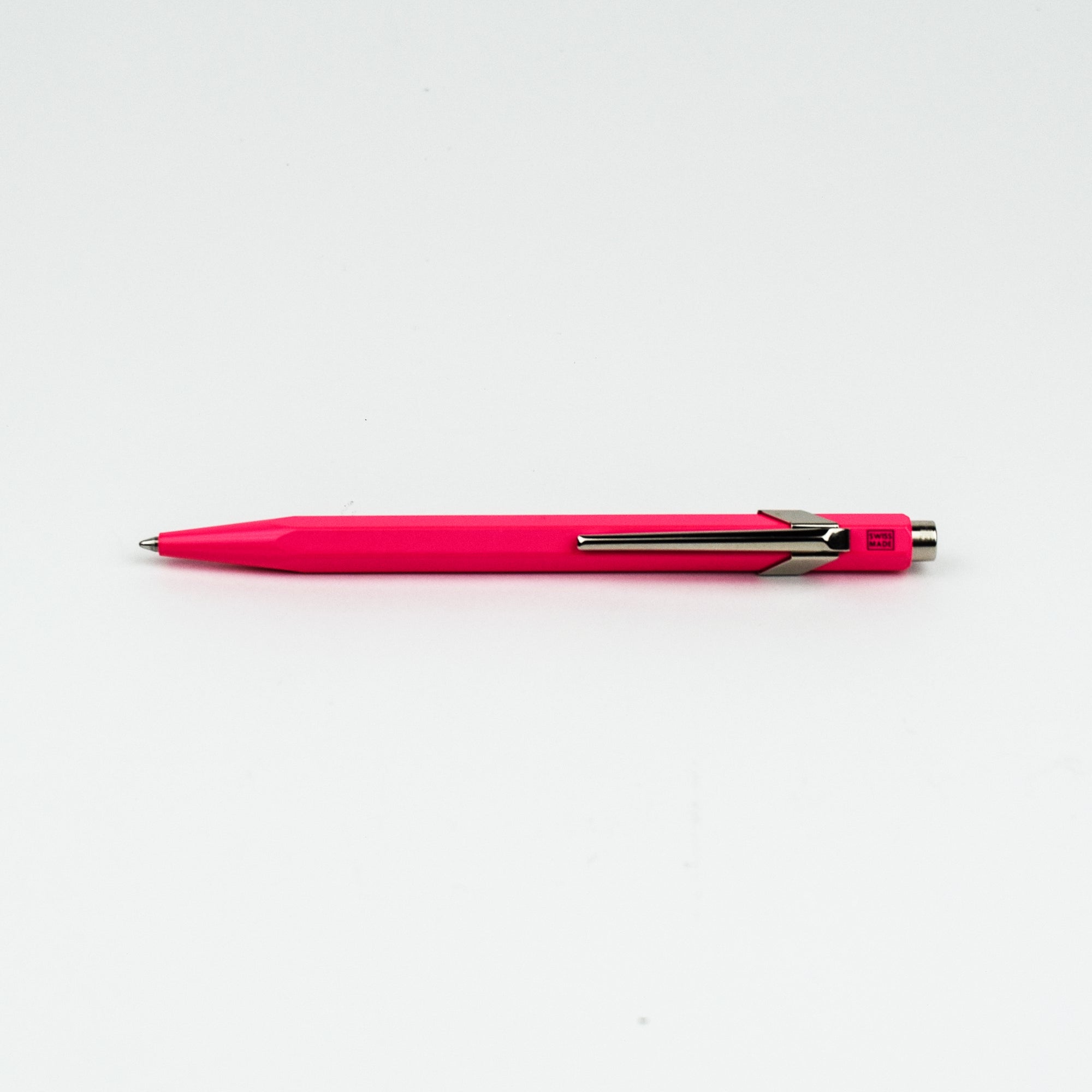 Pink pen with silver clip on a white background