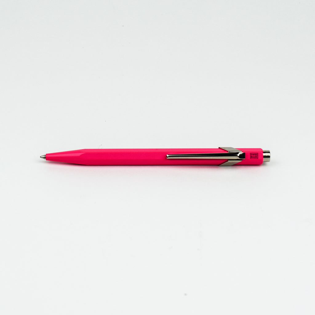 Pink pen with silver clip on a white background