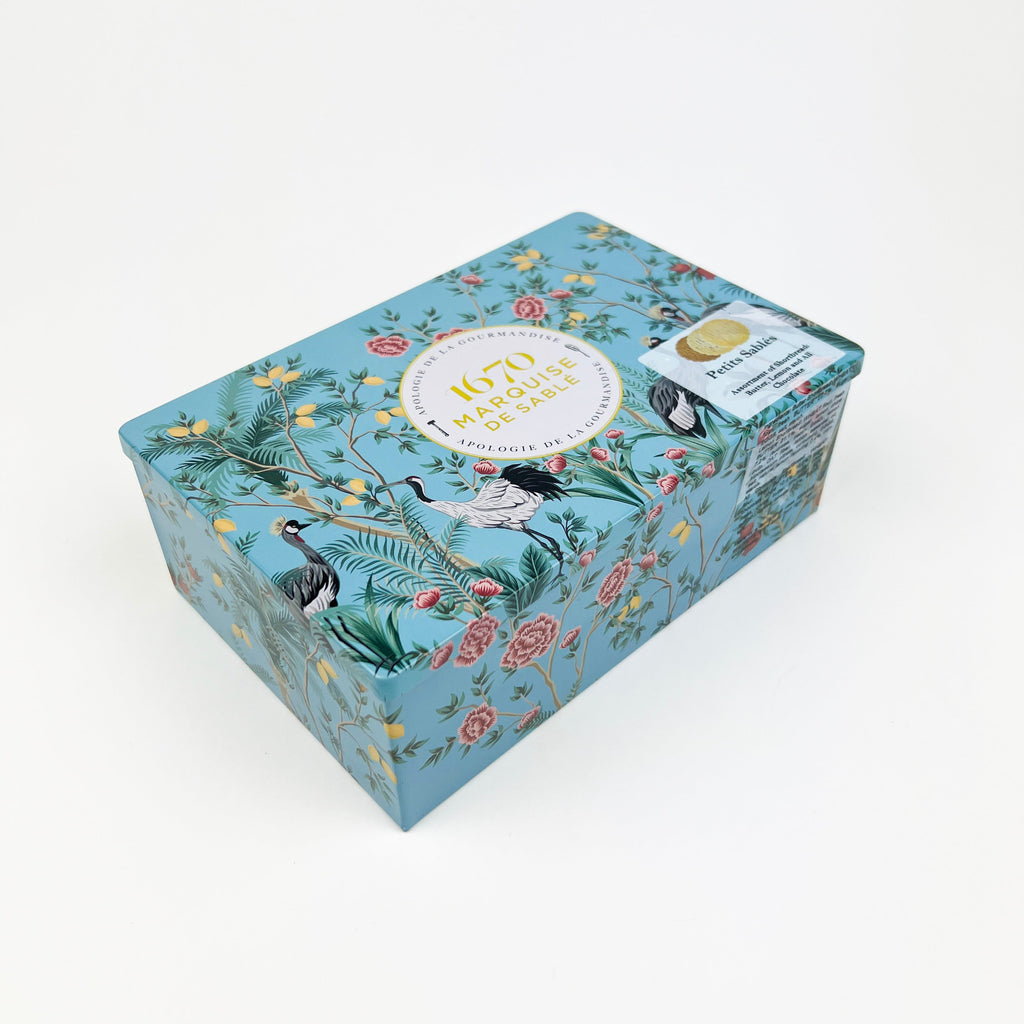 Decorative shortbread tin with a floral design on a white background