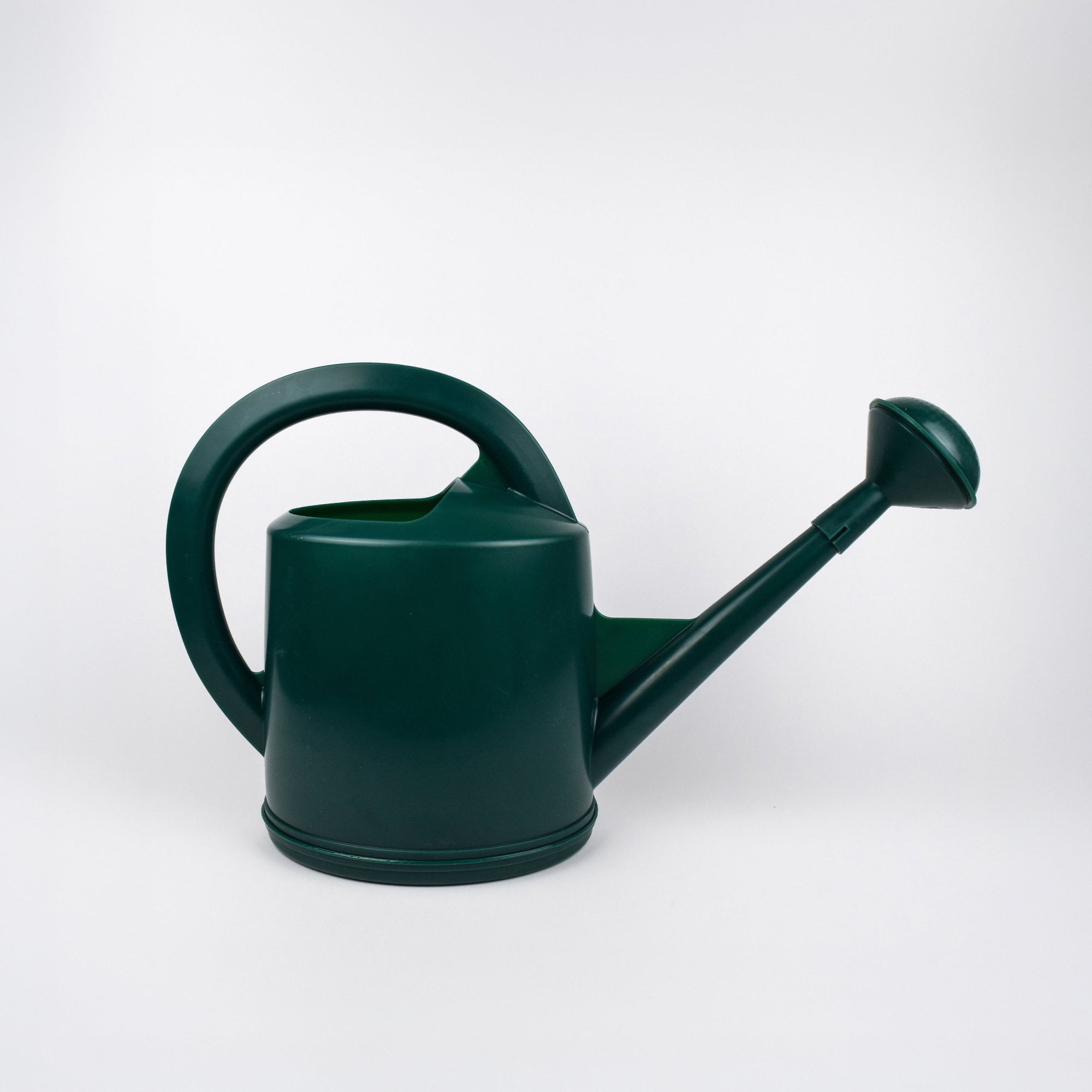 Green watering can on a white background