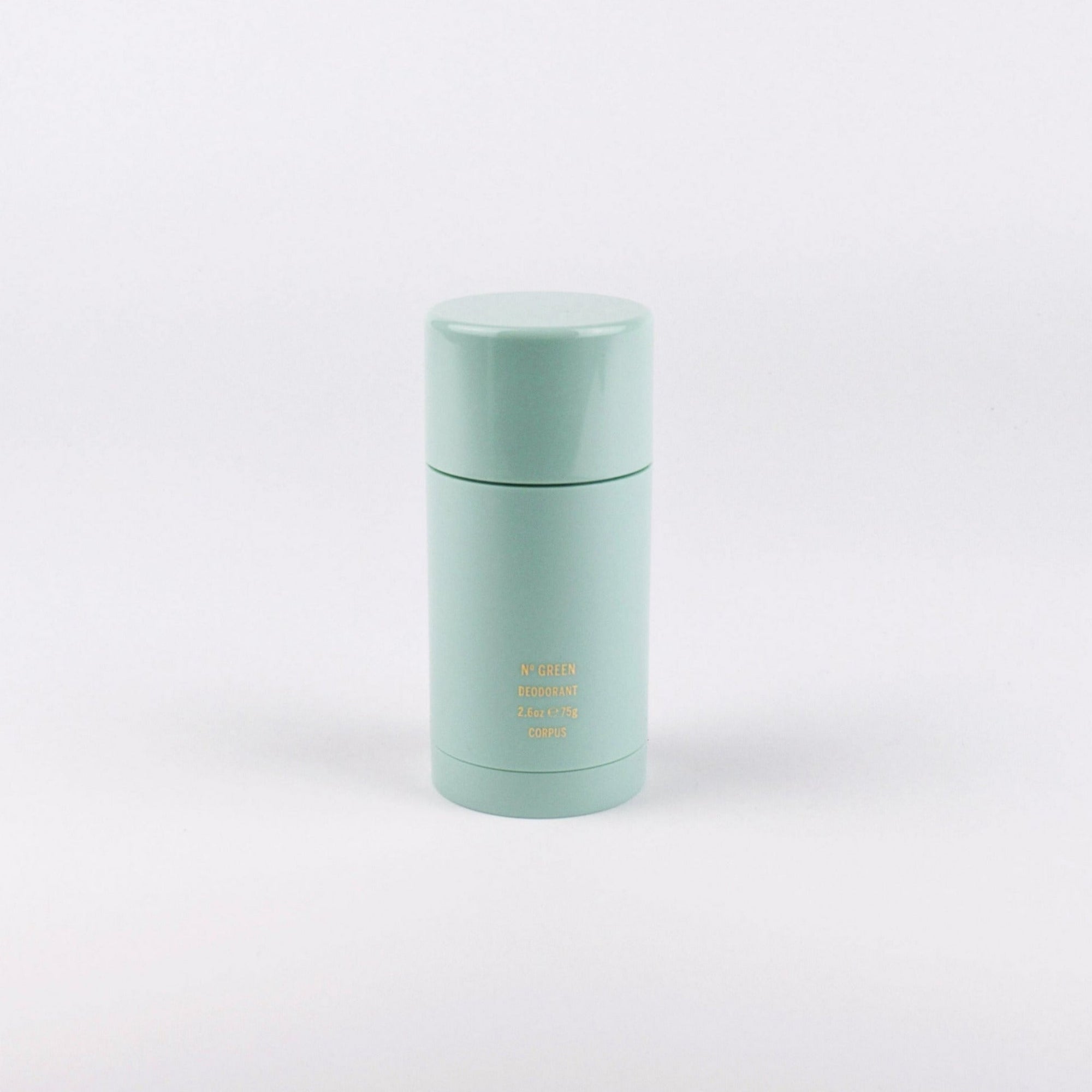 A mint green cylindrical bottle with a matching screw cap, featuring small gold text on the front that reads 'MADE IN THE USA' and '16 OZ', set against a plain white background.