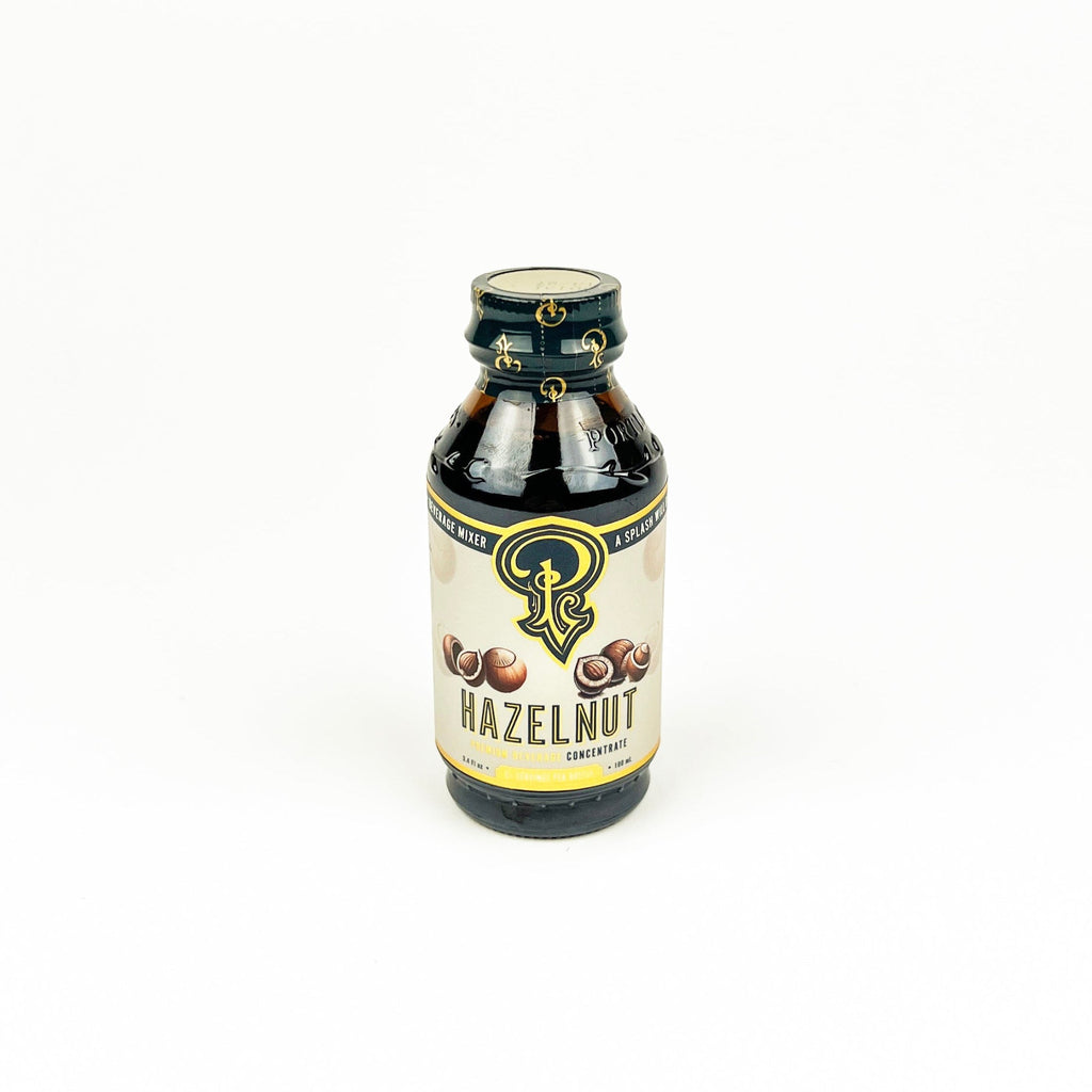 Bottle of hazelnut flavor syrup on a white background