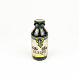 Bottle of hazelnut flavor syrup on a white background