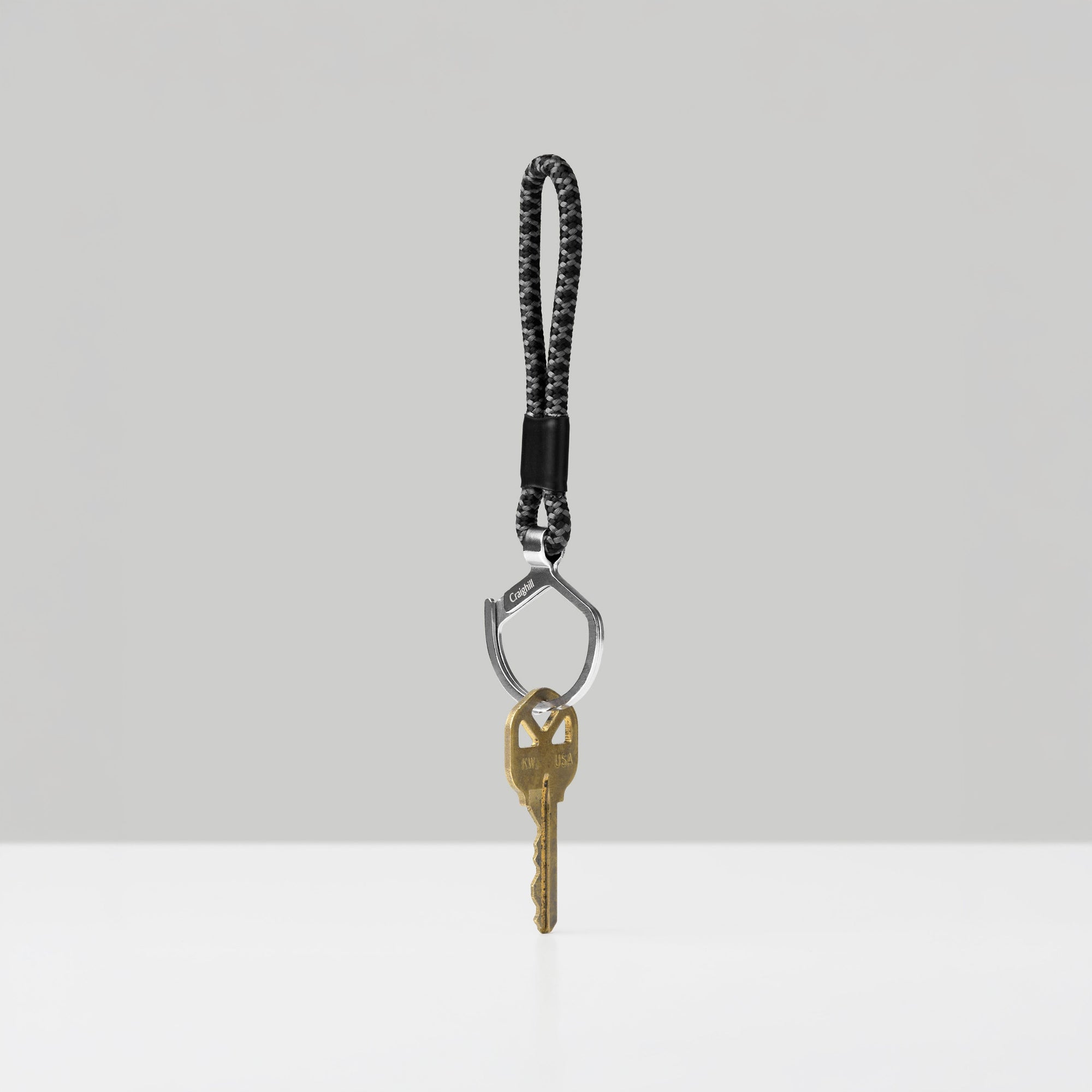 Keychain with a key on a light gray background