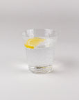 Clear glass with a lemon slice on a white background