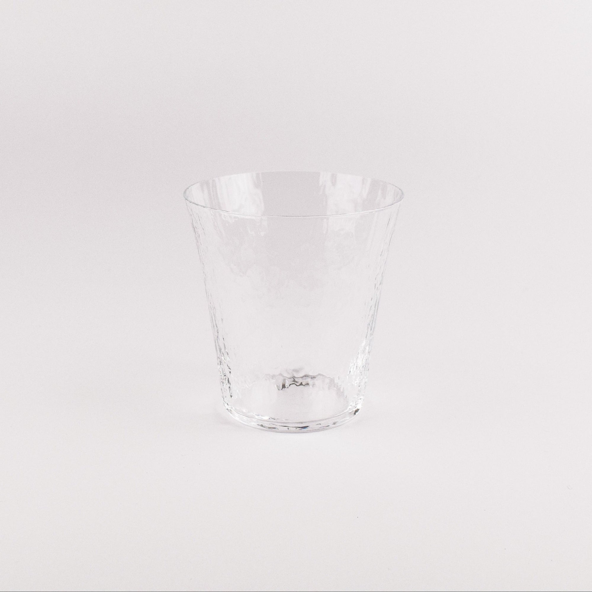 Clear glass tumbler on a white background