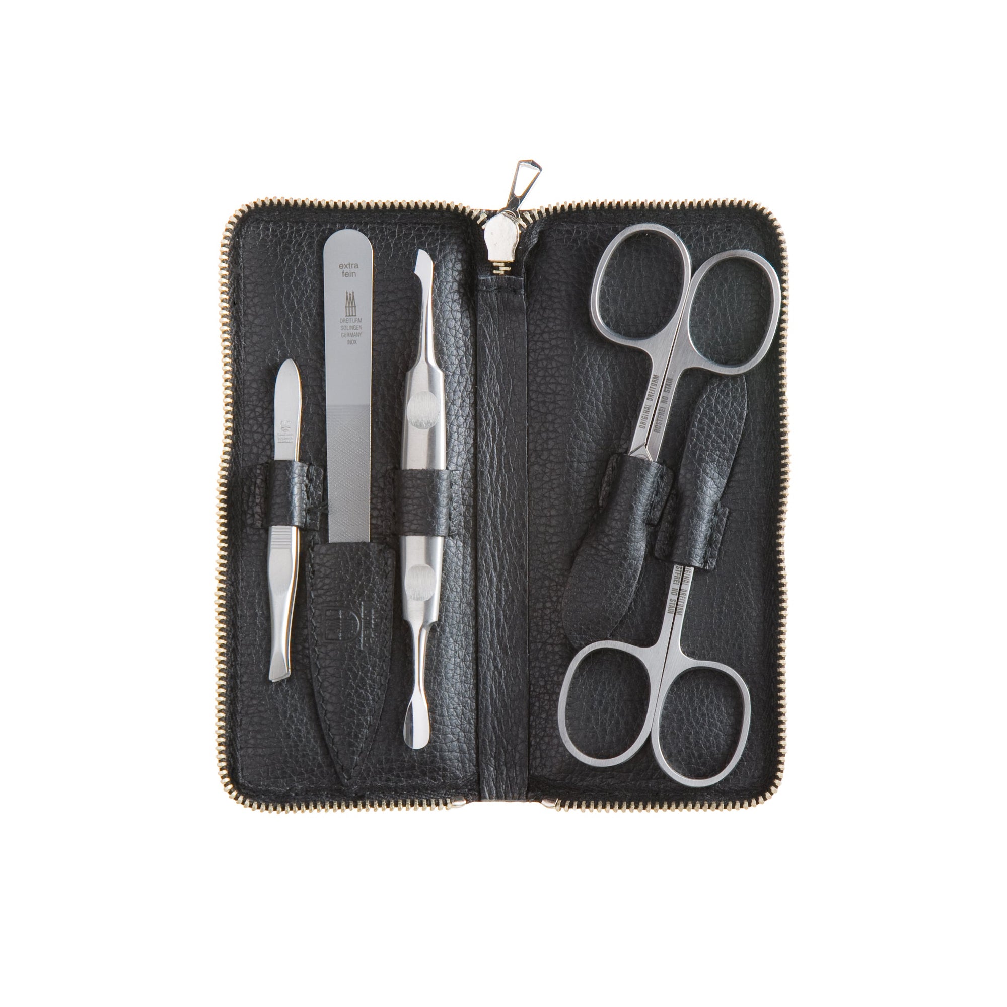 Manicure set with two scissors, nail file, cuticle tool and tweezers in a black leather case on a white background