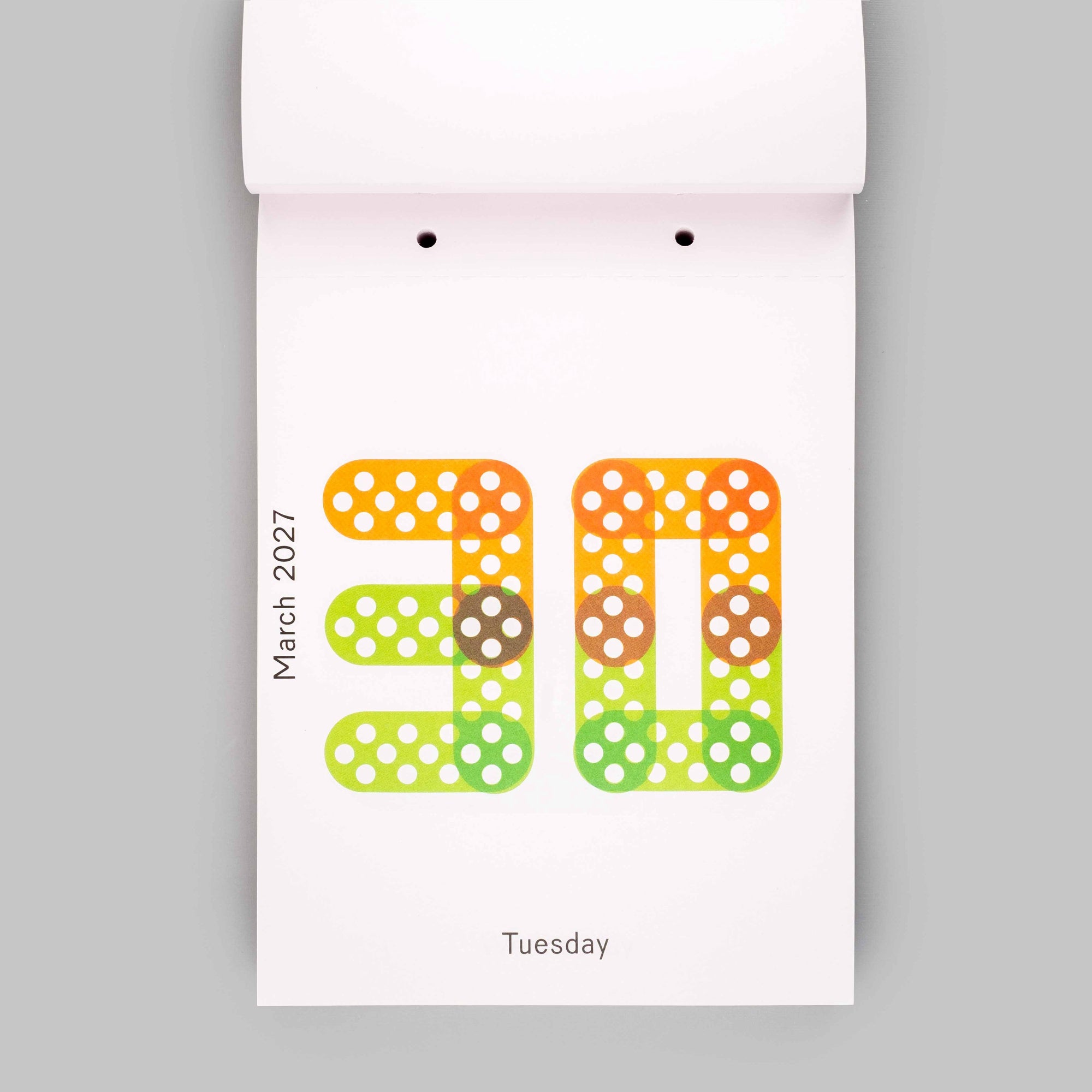 A minimalist desk calendar page showing the date March 30, 2027, as a large dotted number 30 on a white page, with 'Tuesday' printed below, set against a solid gray background.