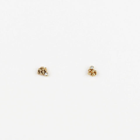 Pair of gold stud earrings on a white background
