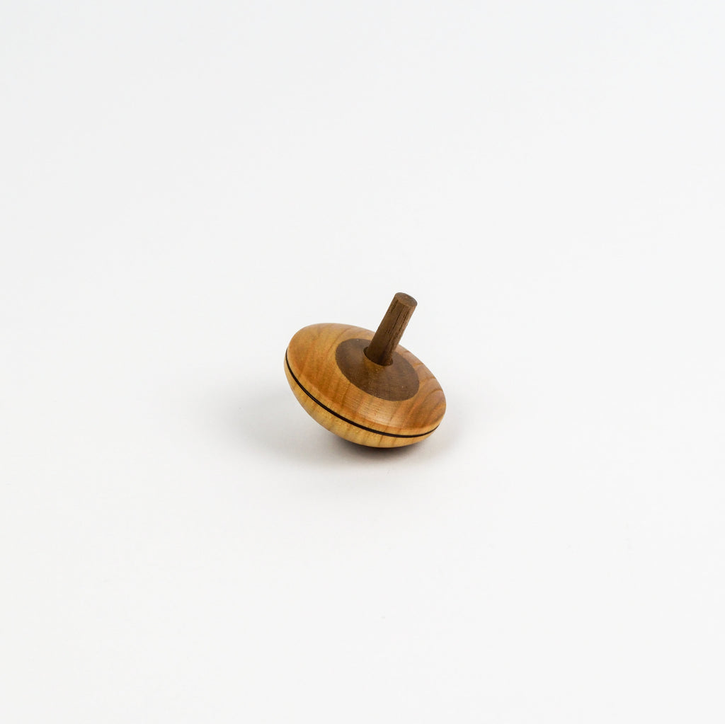 Wooden spinning top on a white background