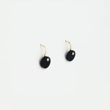 Pair of black earrings with gold accents on a white background