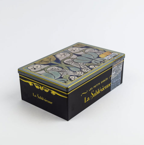 Decorative box with floral design and 'La Sablésienne' branding on a white background