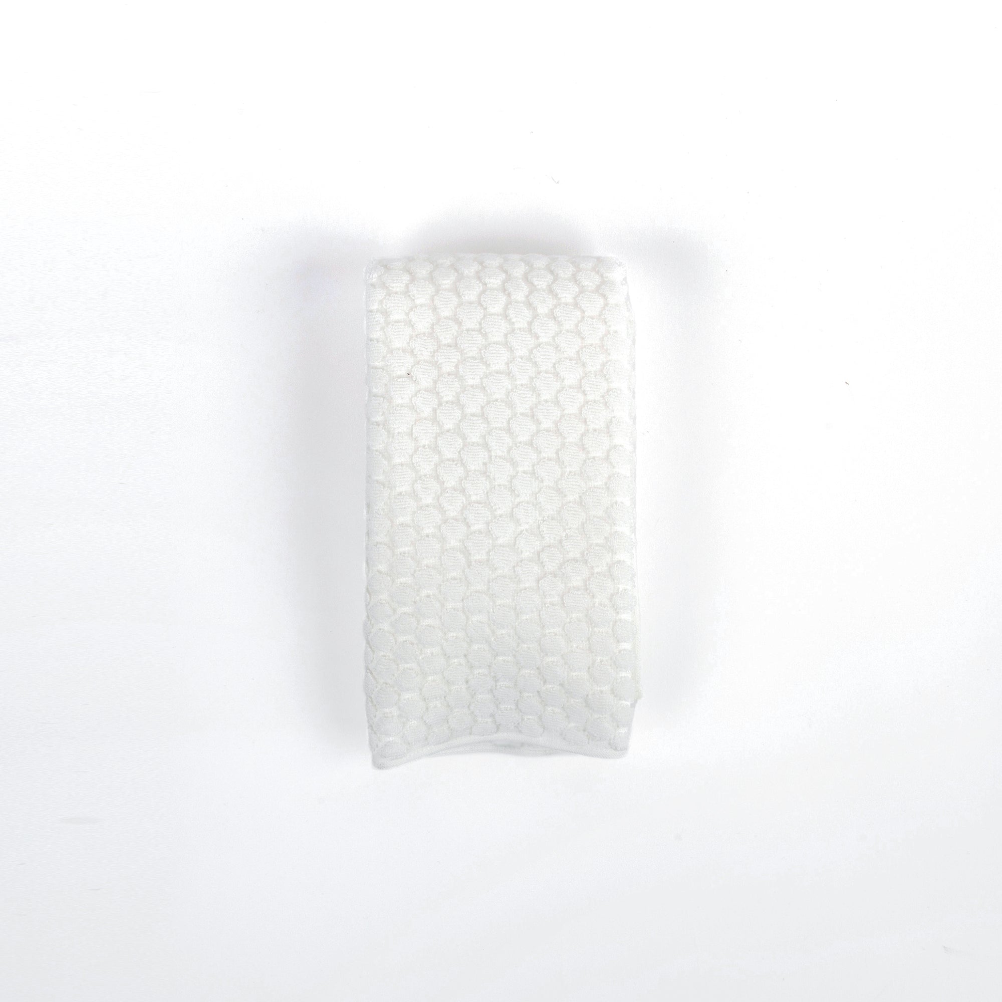 White towel with a subtle pattern on a white background