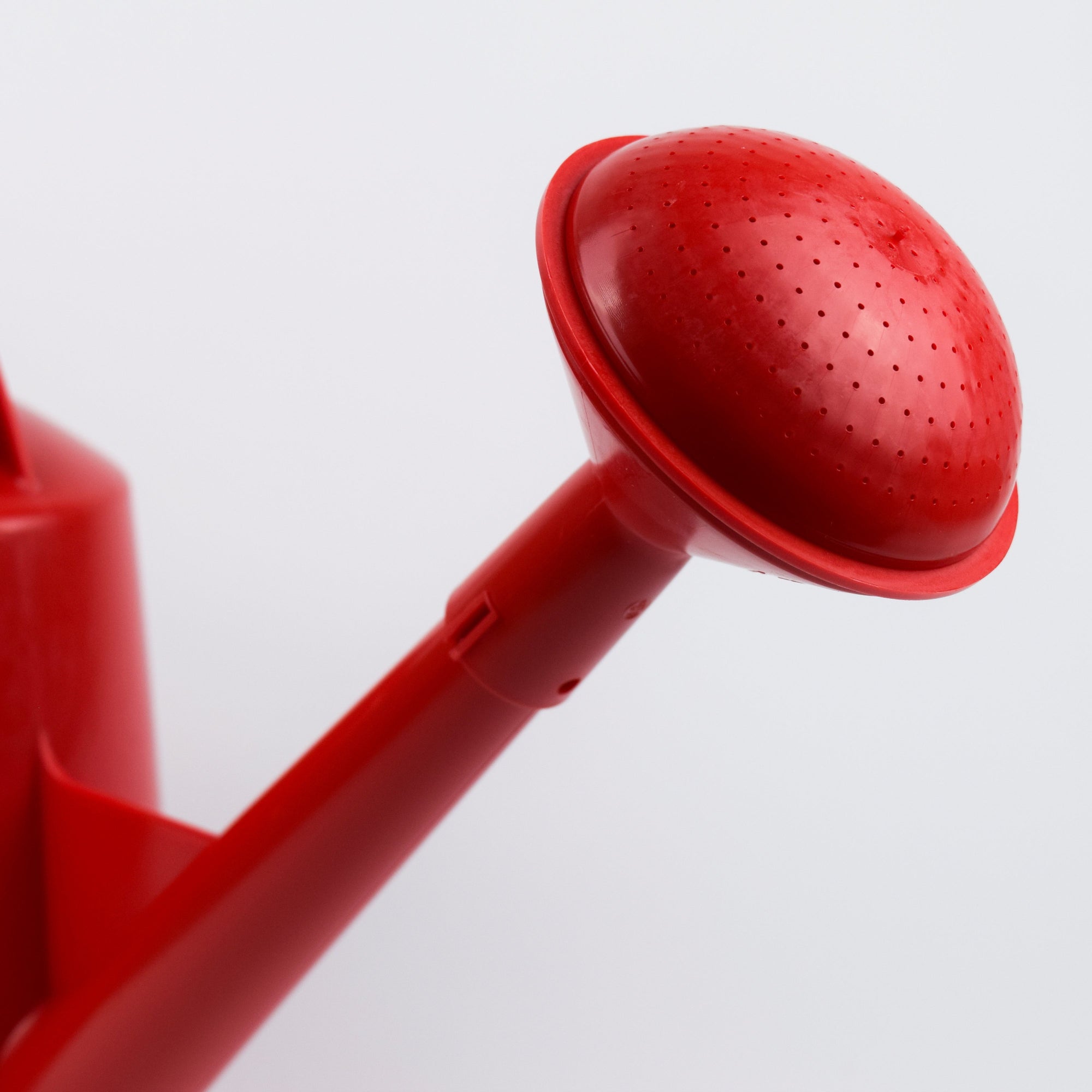 Red shower head on a white background