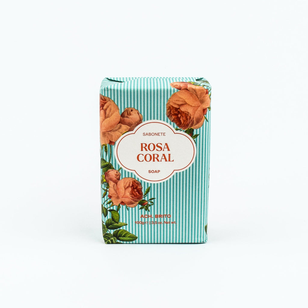 Bar of soap with 'Rosa Coral' branding on a striped box against a white background