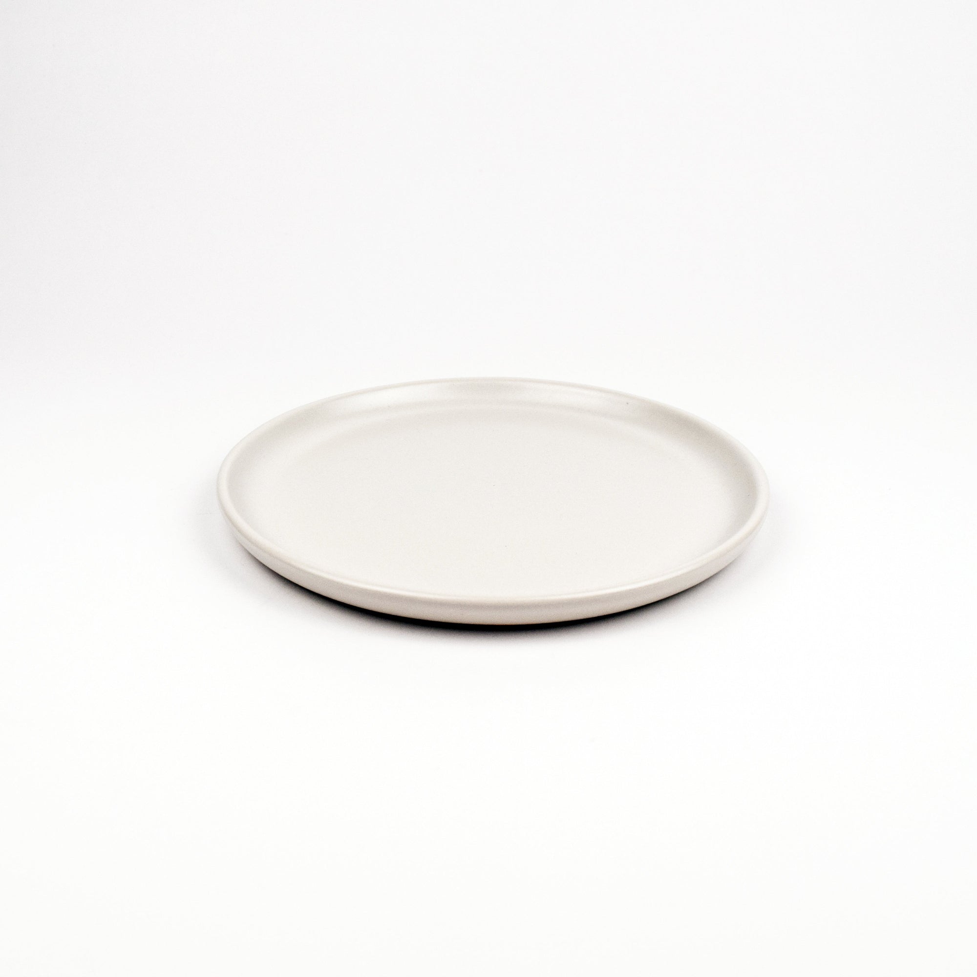White ceramic plate on a white background
