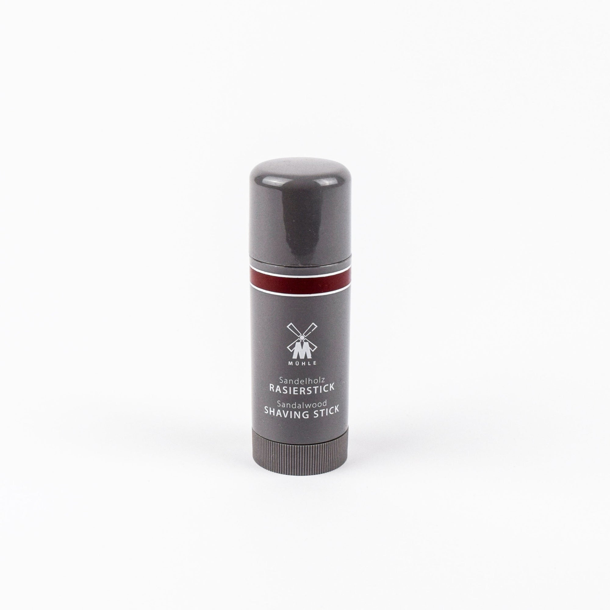 Shaving stick with gray and red design on a white background