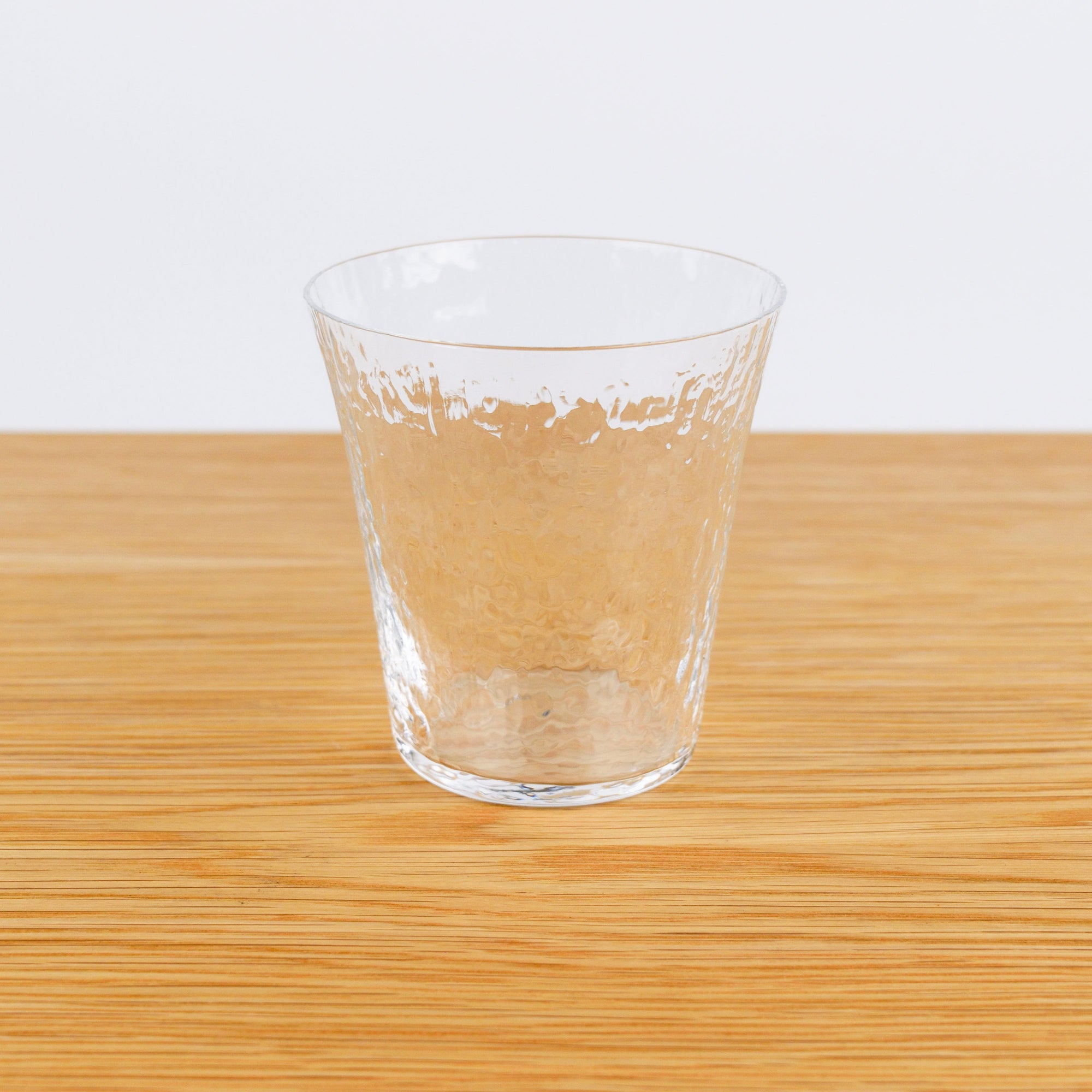 Clear glass on a wooden surface with a white background