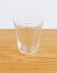 Clear glass on a wooden surface with a white background